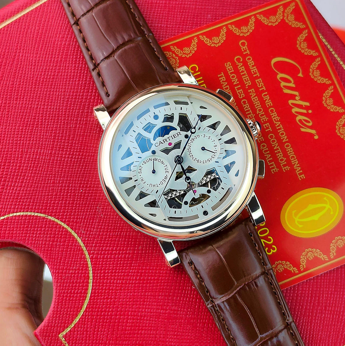 CA_TIER AUTOMATIC WATCH WITH A SKELETONIZED DIAL A BROWN LEATHER STRAP DAY AND DATE INDICATORS_J19